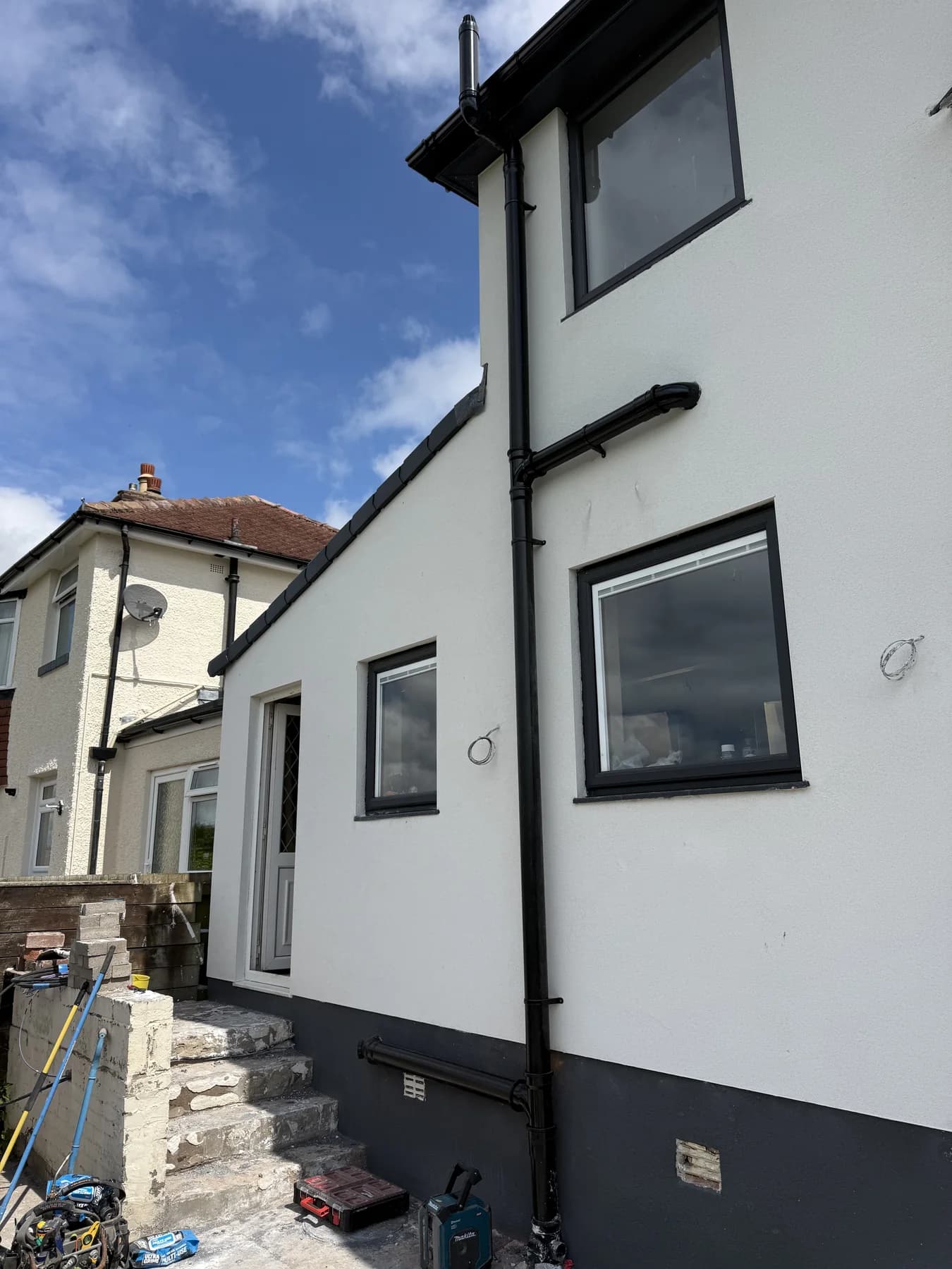 New external black soil and waste pipework fitted to a house
